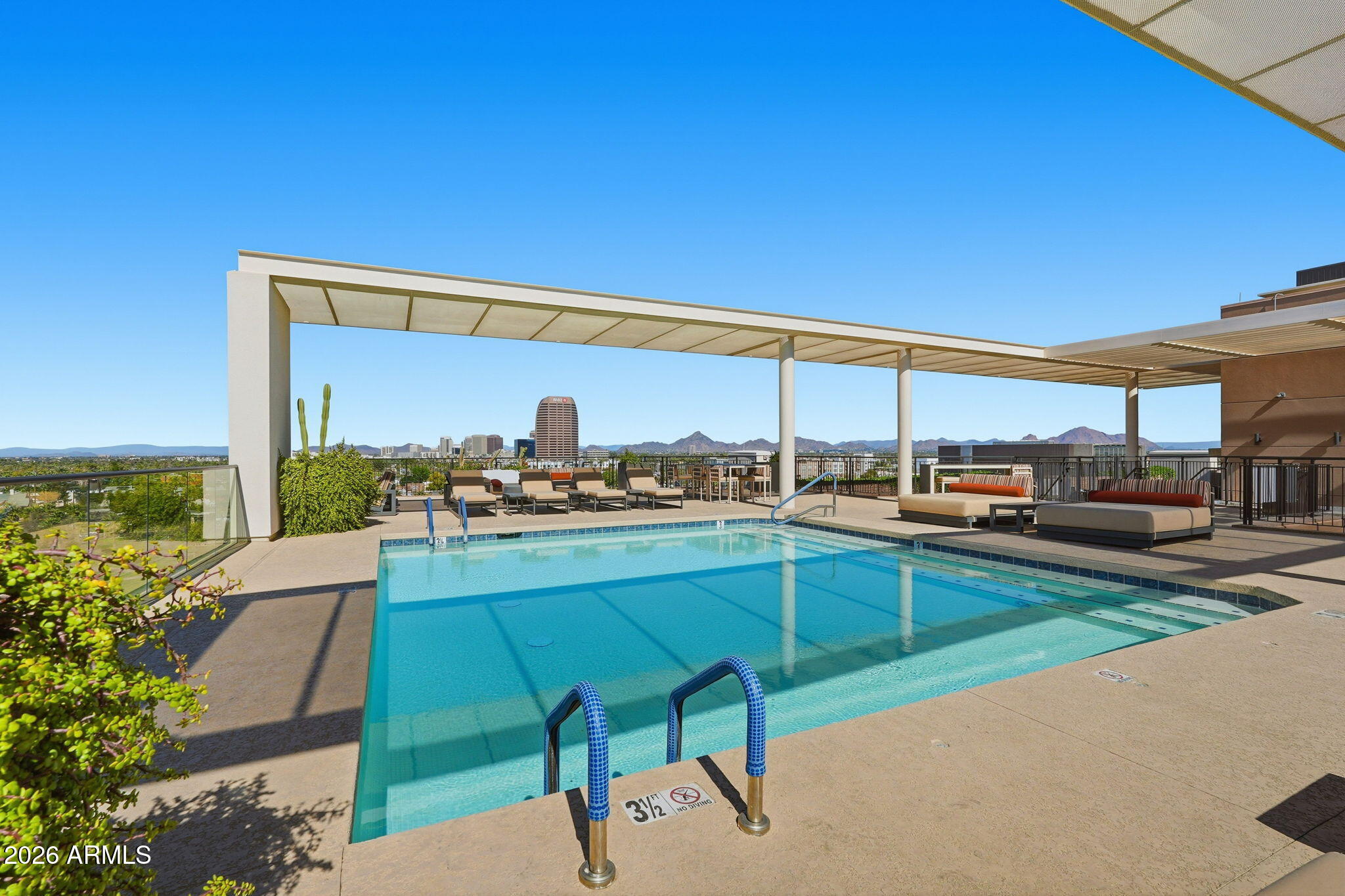 208 West Portland Street, Unit 155 Phoenix, AZ 85003 - Photo 21 of 36 a view of a terrace with a table and chairs