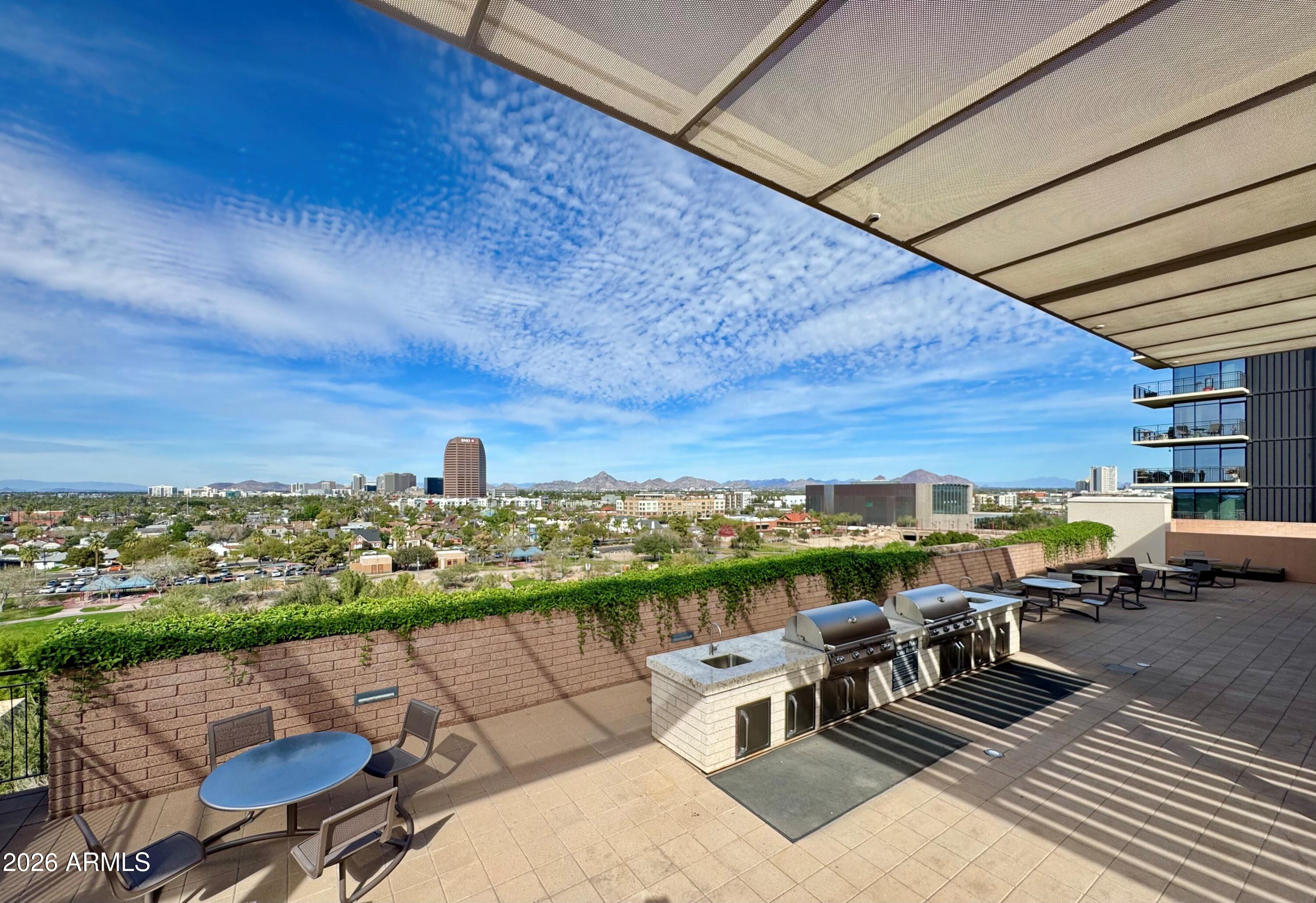 208 West Portland Street, Unit 155 Phoenix, AZ 85003 - Photo 25 of 36 a view of a terrace with outdoor seating and city view