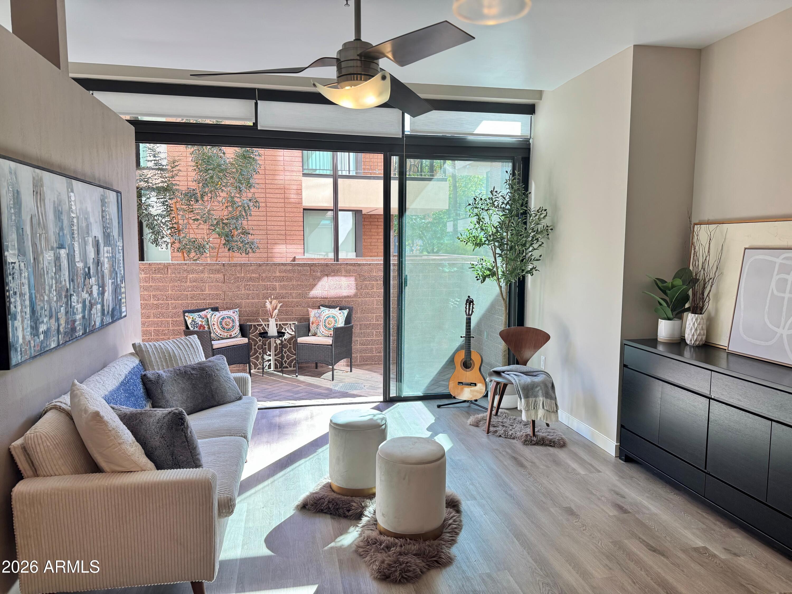 208 West Portland Street, Unit 155 Phoenix, AZ 85003 - Photo 3 of 36 a living room with furniture and a large window