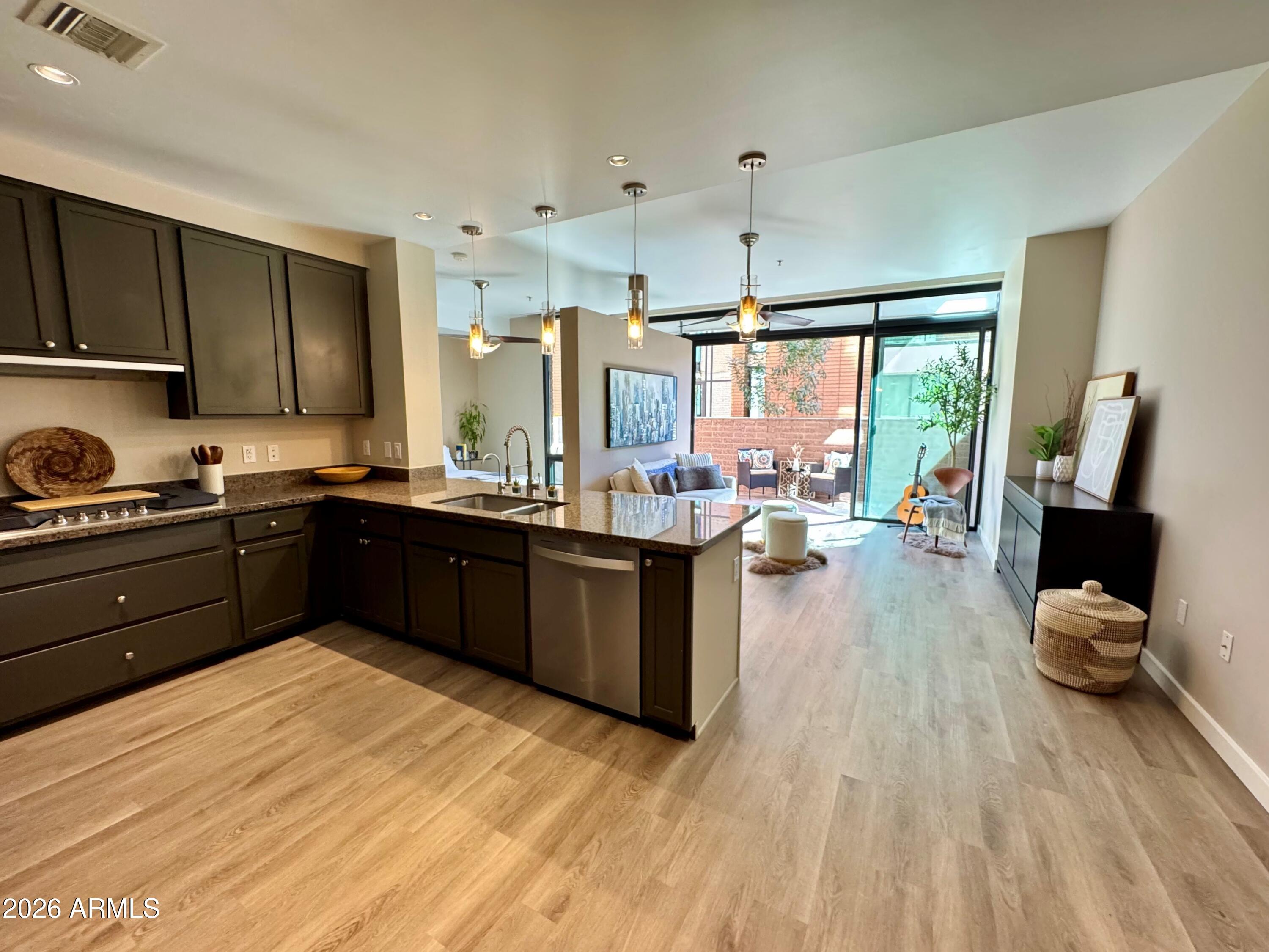 208 West Portland Street, Unit 155 Phoenix, AZ 85003 - Photo 5 of 36 a kitchen with a sink appliances and cabinets