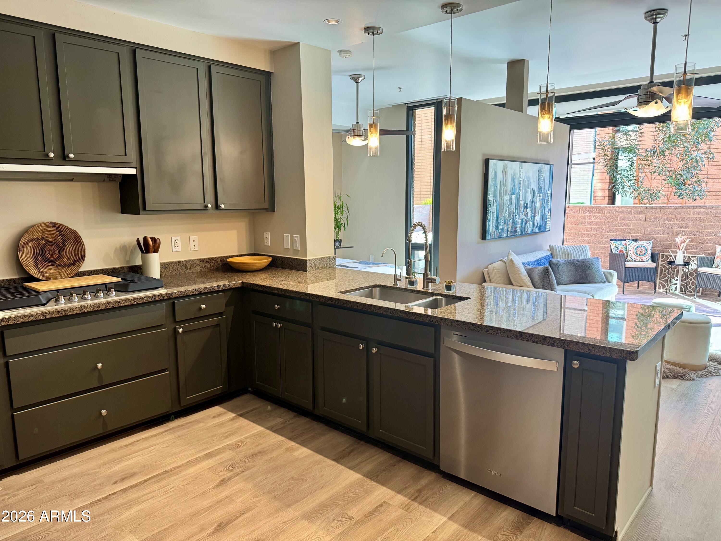208 West Portland Street, Unit 155 Phoenix, AZ 85003 - Photo 6 of 36 a kitchen with a sink stove and cabinets