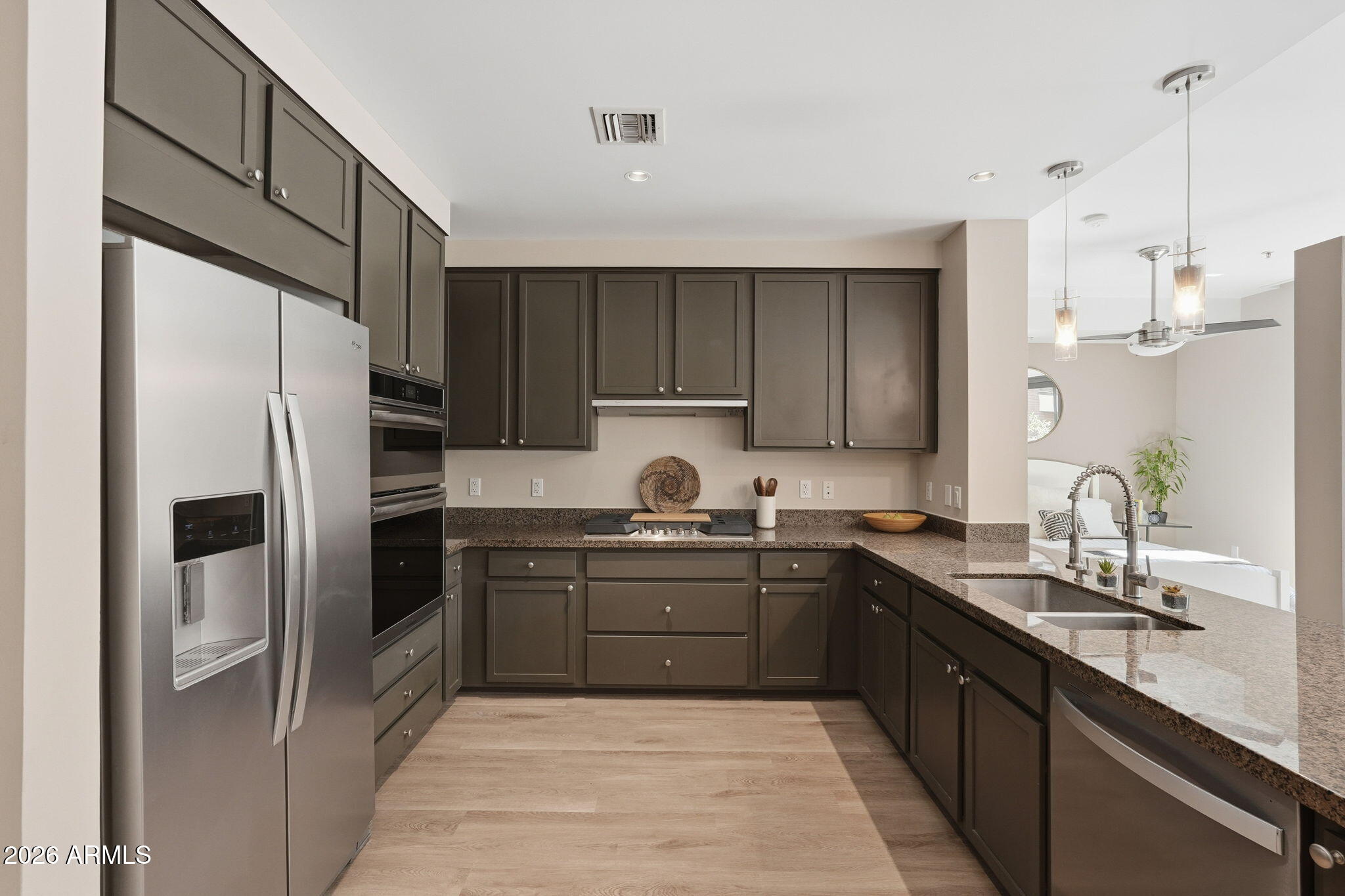 208 West Portland Street, Unit 155 Phoenix, AZ 85003 - Photo 7 of 36 a kitchen with kitchen island granite countertop a sink stainless steel appliances and cabinets