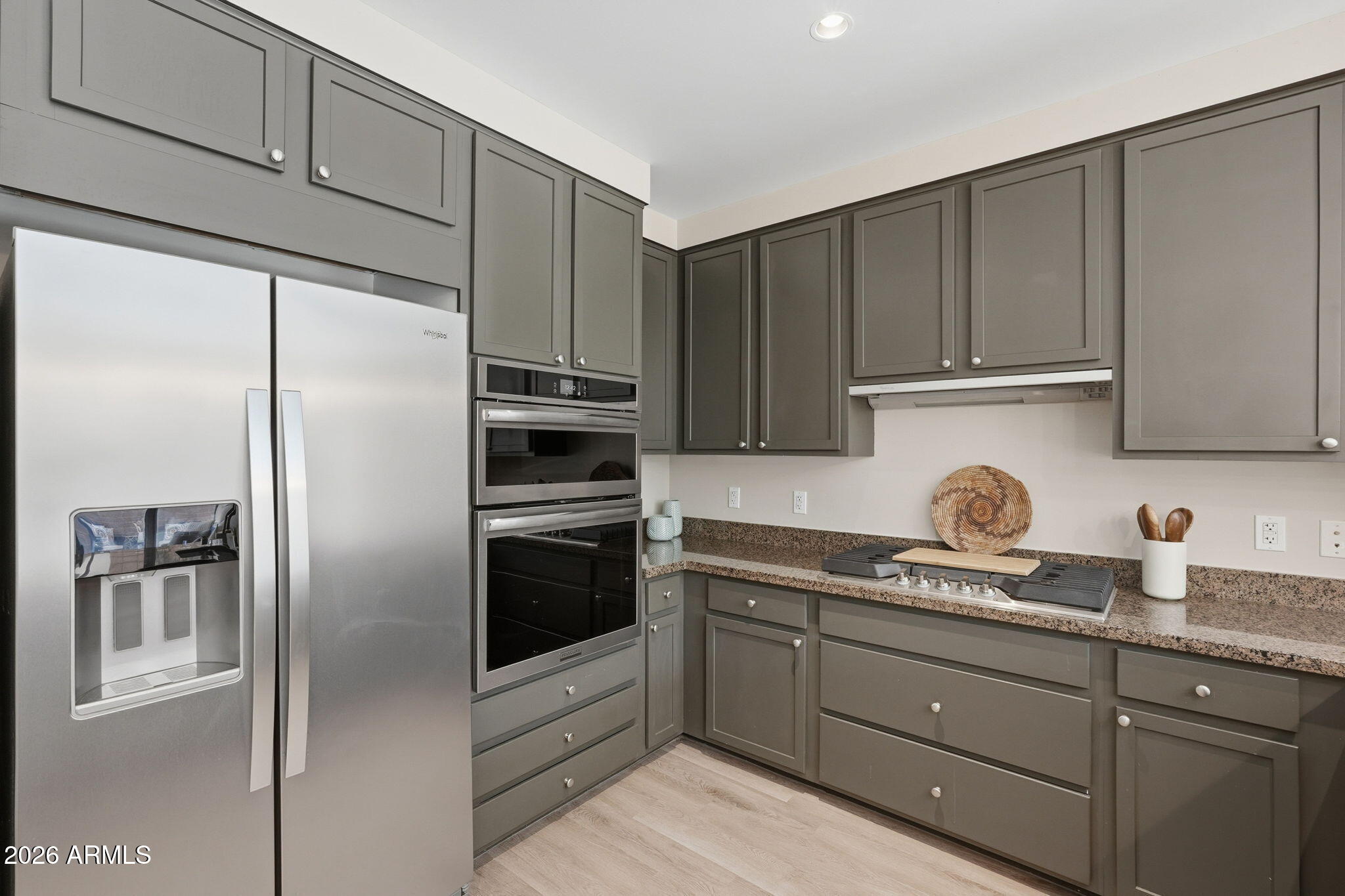 208 West Portland Street, Unit 155 Phoenix, AZ 85003 - Photo 8 of 36 a kitchen with stainless steel appliances granite countertop a refrigerator sink and microwave