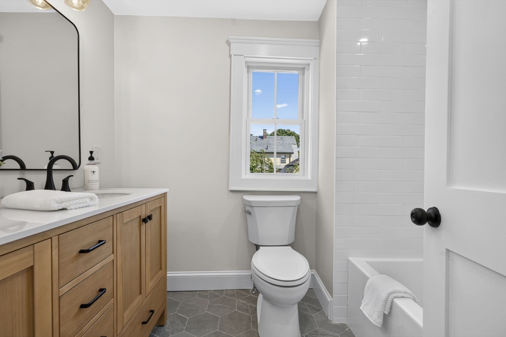 20 Saltonstall Road Medford, MA 02155 - Photo 32 of 41 a bathroom with a toilet sink and mirror