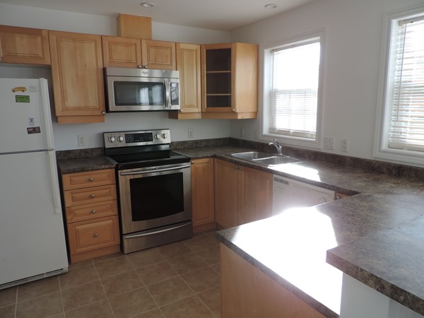 32 Junction Street, Unit 5 Needham, MA 02492 - Photo 2 of 4 a kitchen with granite countertop a stove and a sink