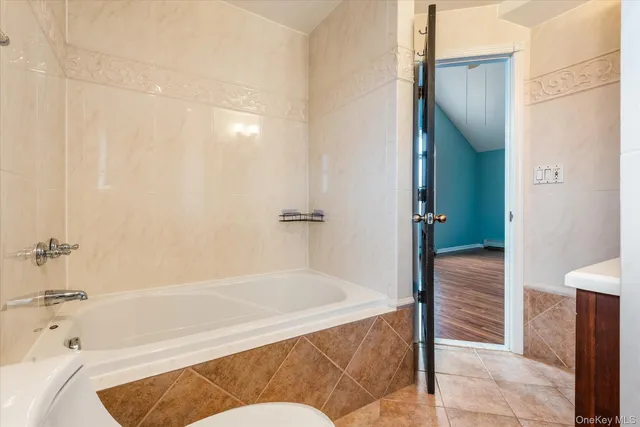 a bathroom with a bathtub and shower