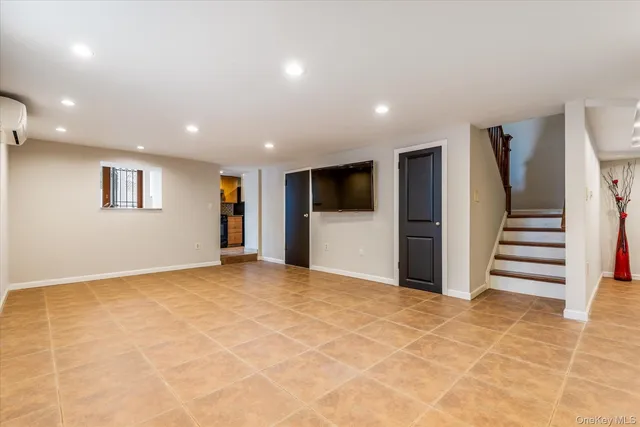 a view of empty room with wooden floor and windows