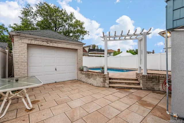 a view of a terrace with glass top table and chairs