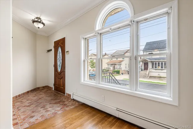 a view of an entryway with wooden floor
