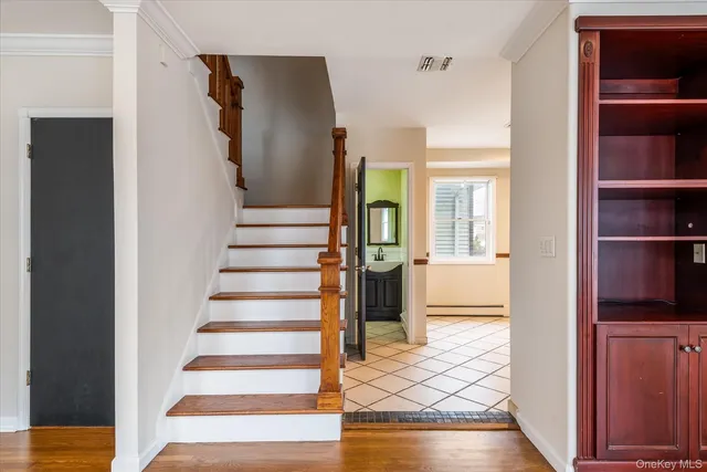 a view of a hallway with wooden floor and entryway