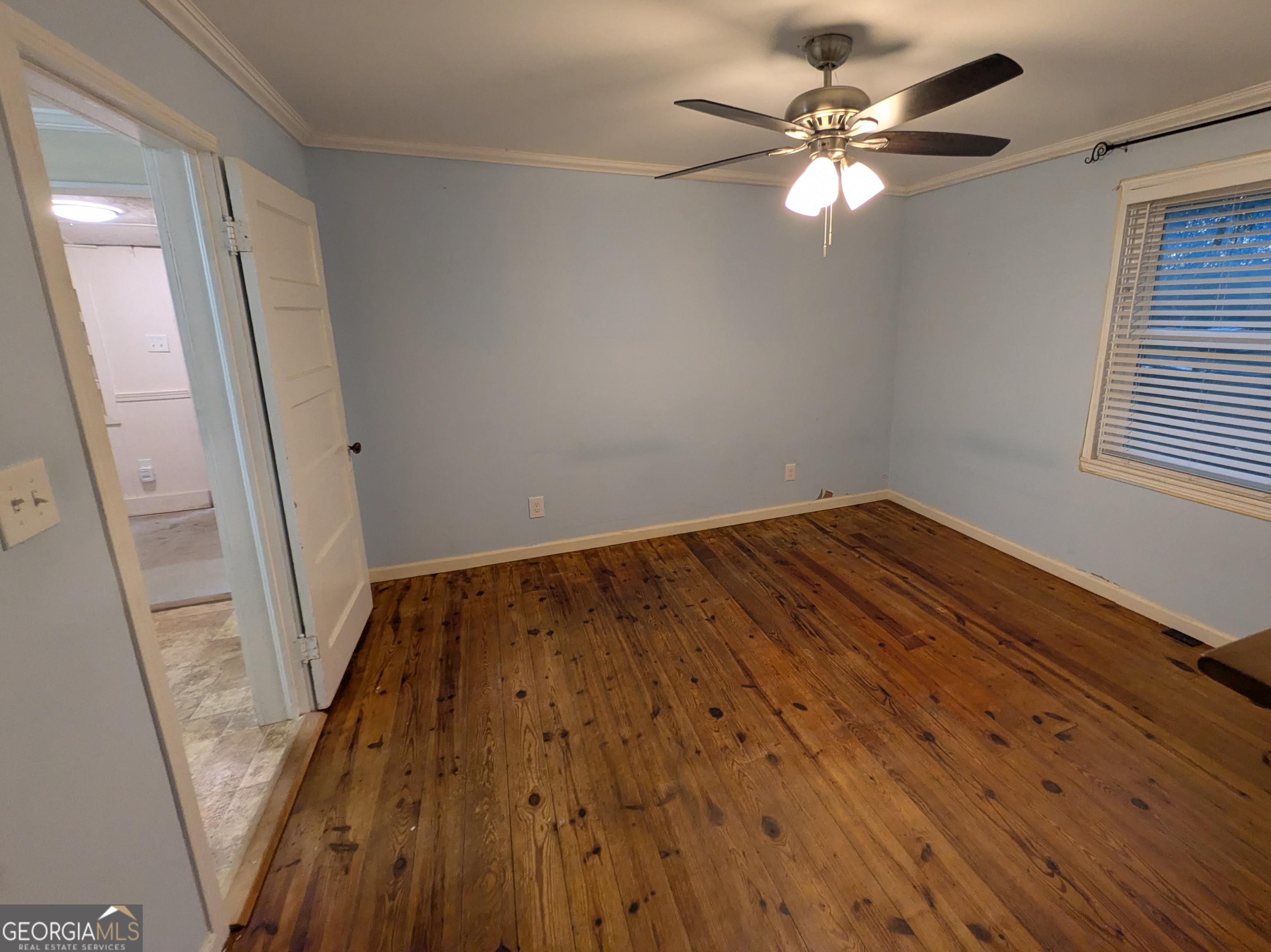 173 Baugh Street Commerce, GA 30529 - Photo 21 of 24 wooden floor in an empty room with a window