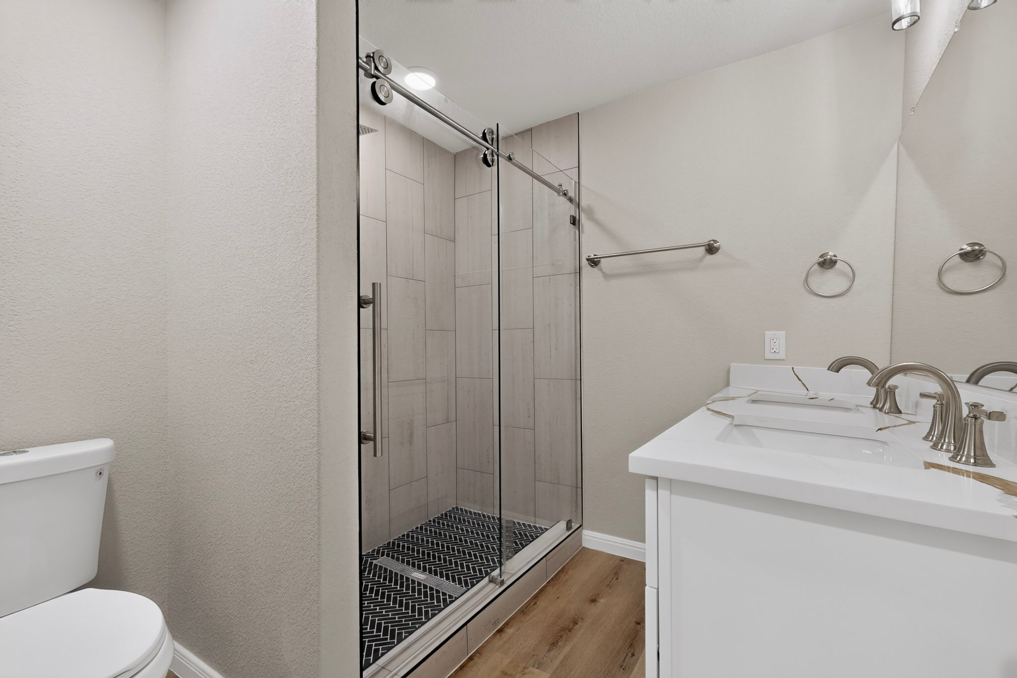 158 Fealy Road Red Rock, TX 78662 - Photo 22 of 40 Clean lines and a modern walk-in shower define this updated bathroom space.