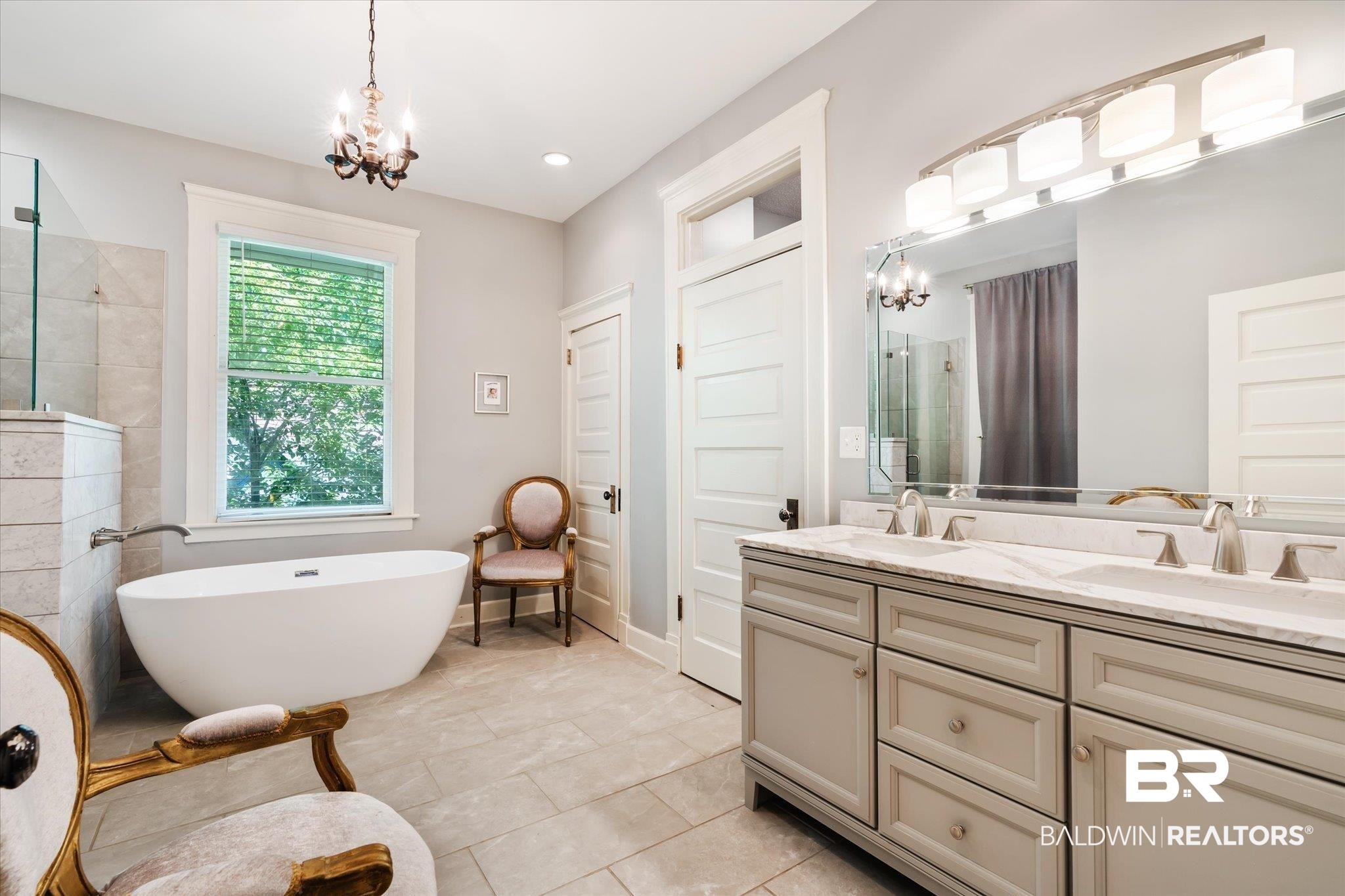 68 North Monterey Street Mobile, AL 36604 - Photo 18 of 30 Bathroom with dual vanity, a chandelier, a bathtub, and tile patterned flooring