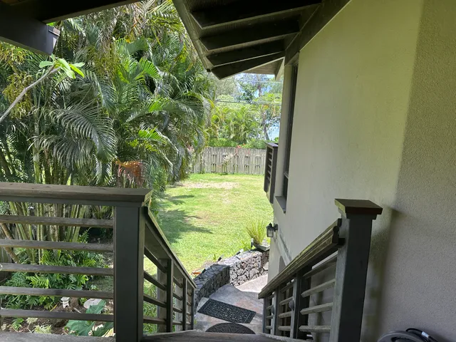 a view of a house with potted plants