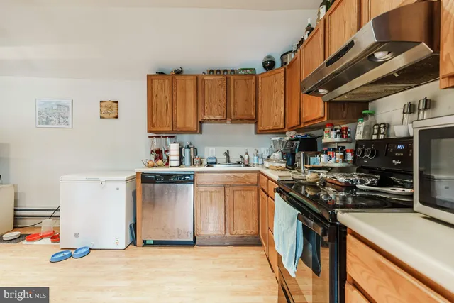 a kitchen with stainless steel appliances granite countertop a stove sink and cabinets