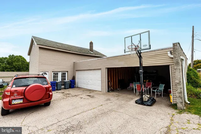a view of a house with patio furniture and a garage