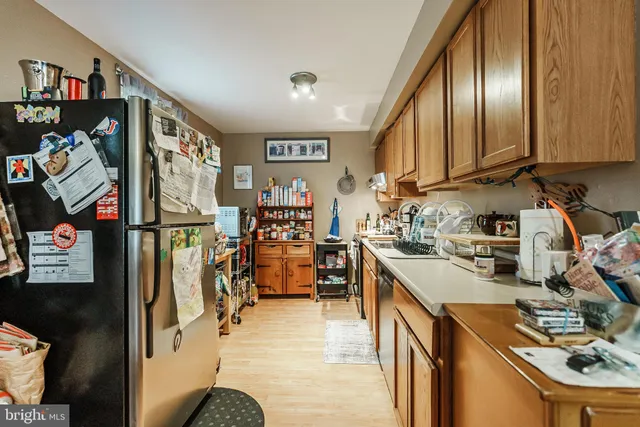 a kitchen with stainless steel appliances granite countertop a refrigerator and stove