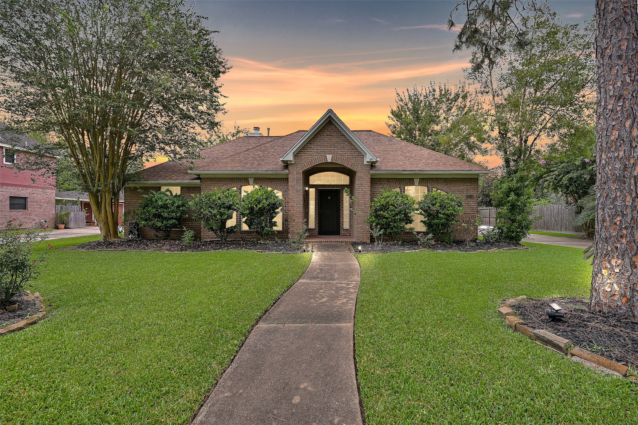 1606 Falcon Ridge Boulevard Friendswood, TX 77546 - Photo 1 of 24 a front view of a house with garden