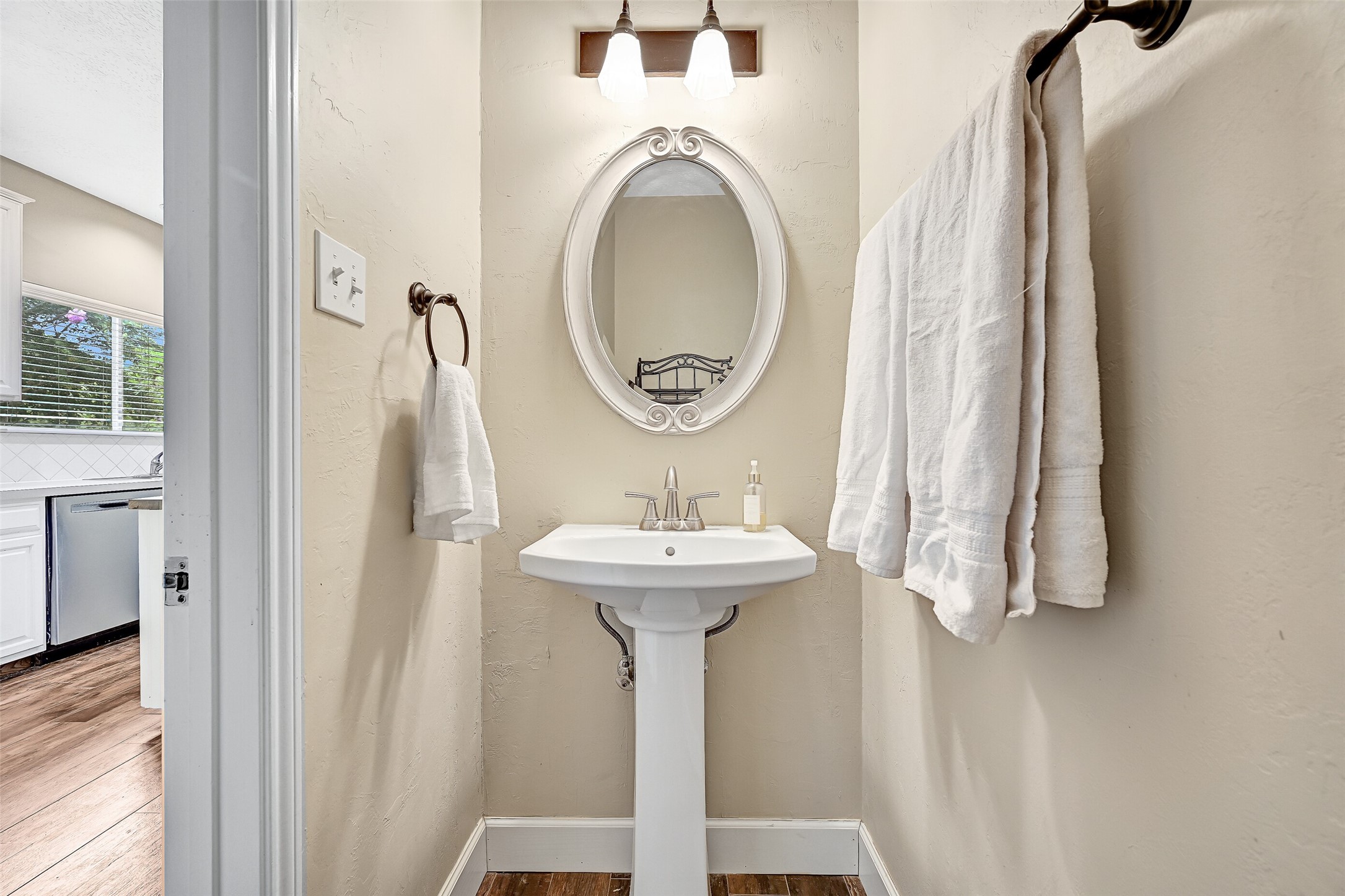 1606 Falcon Ridge Boulevard Friendswood, TX 77546 - Photo 14 of 24 a bathroom with a sink a mirror and a window