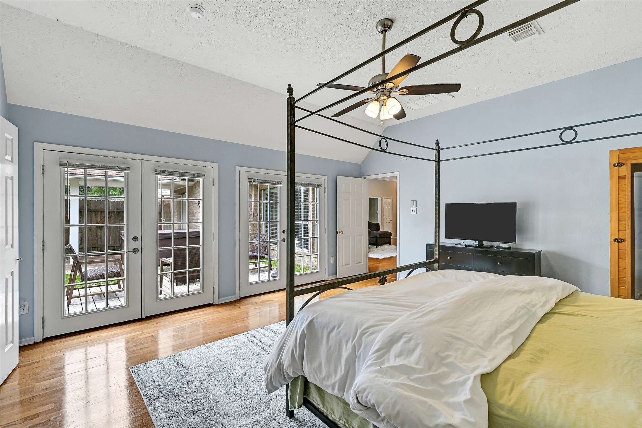 1606 Falcon Ridge Boulevard Friendswood, TX 77546 - Photo 16 of 24 a bedroom with a bed window and flat screen tv