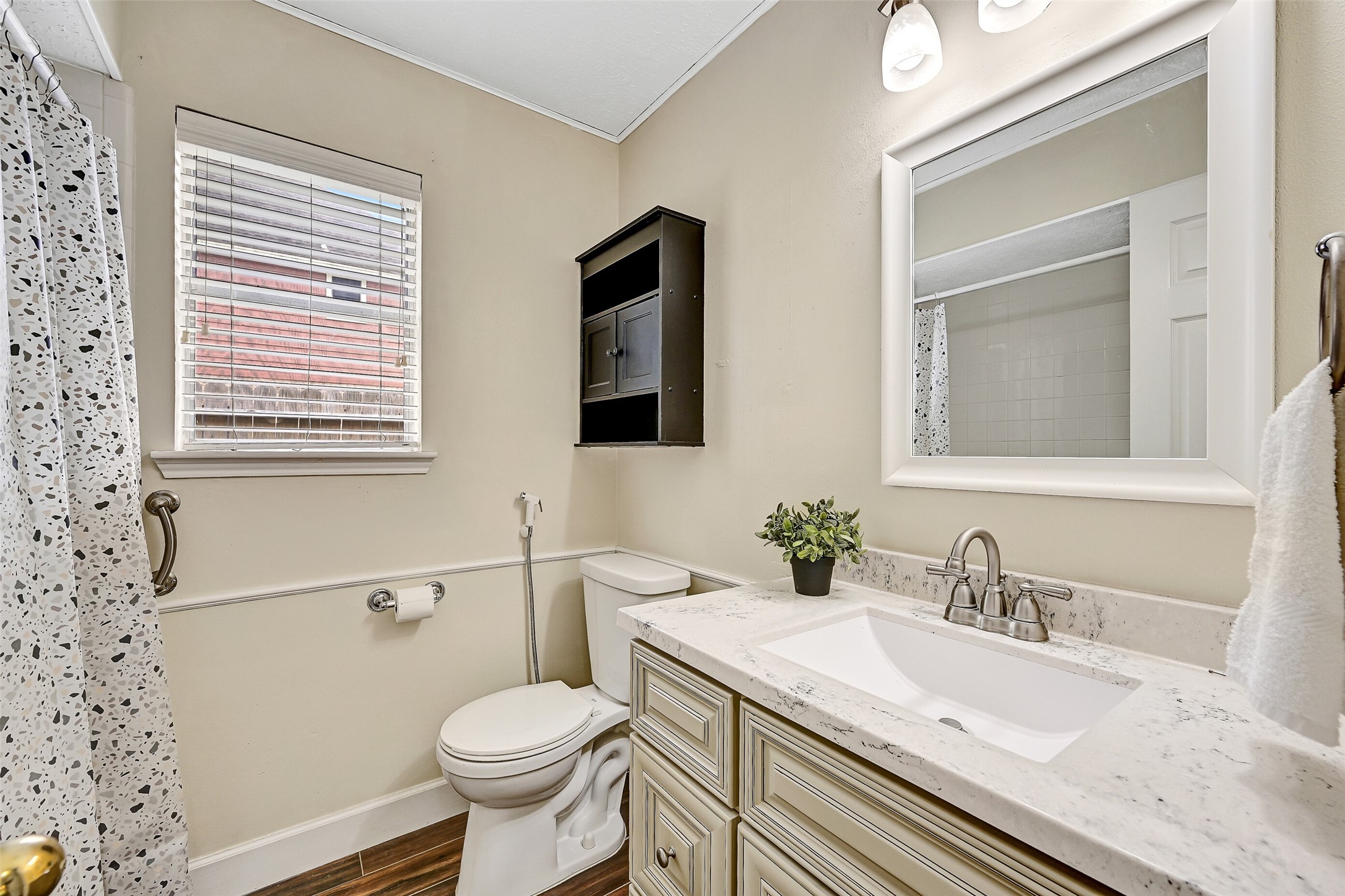 1606 Falcon Ridge Boulevard Friendswood, TX 77546 - Photo 19 of 24 a bathroom with a granite countertop toilet sink and mirror
