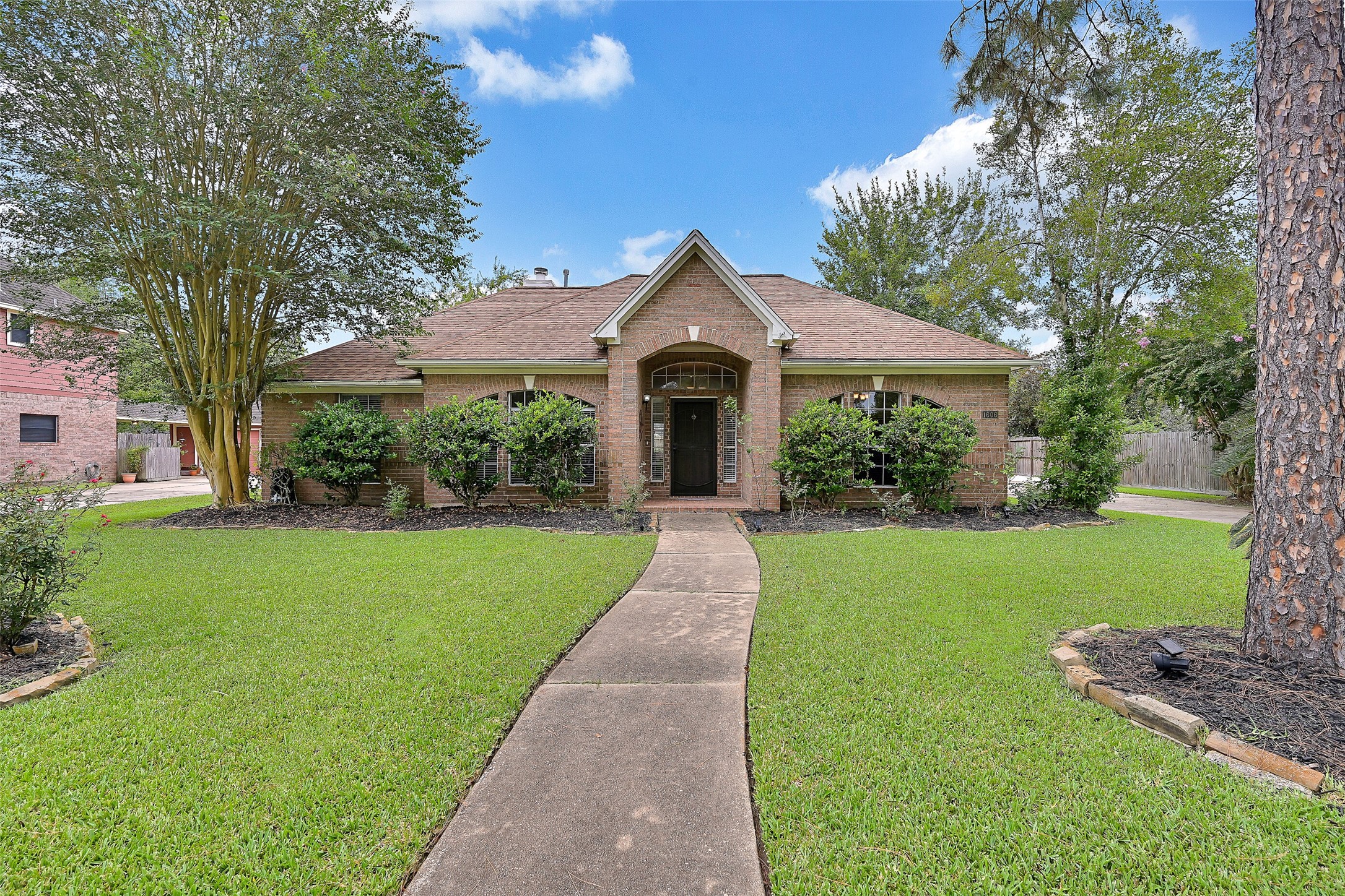 1606 Falcon Ridge Boulevard Friendswood, TX 77546 - Photo 2 of 24 a front view of a house with garden