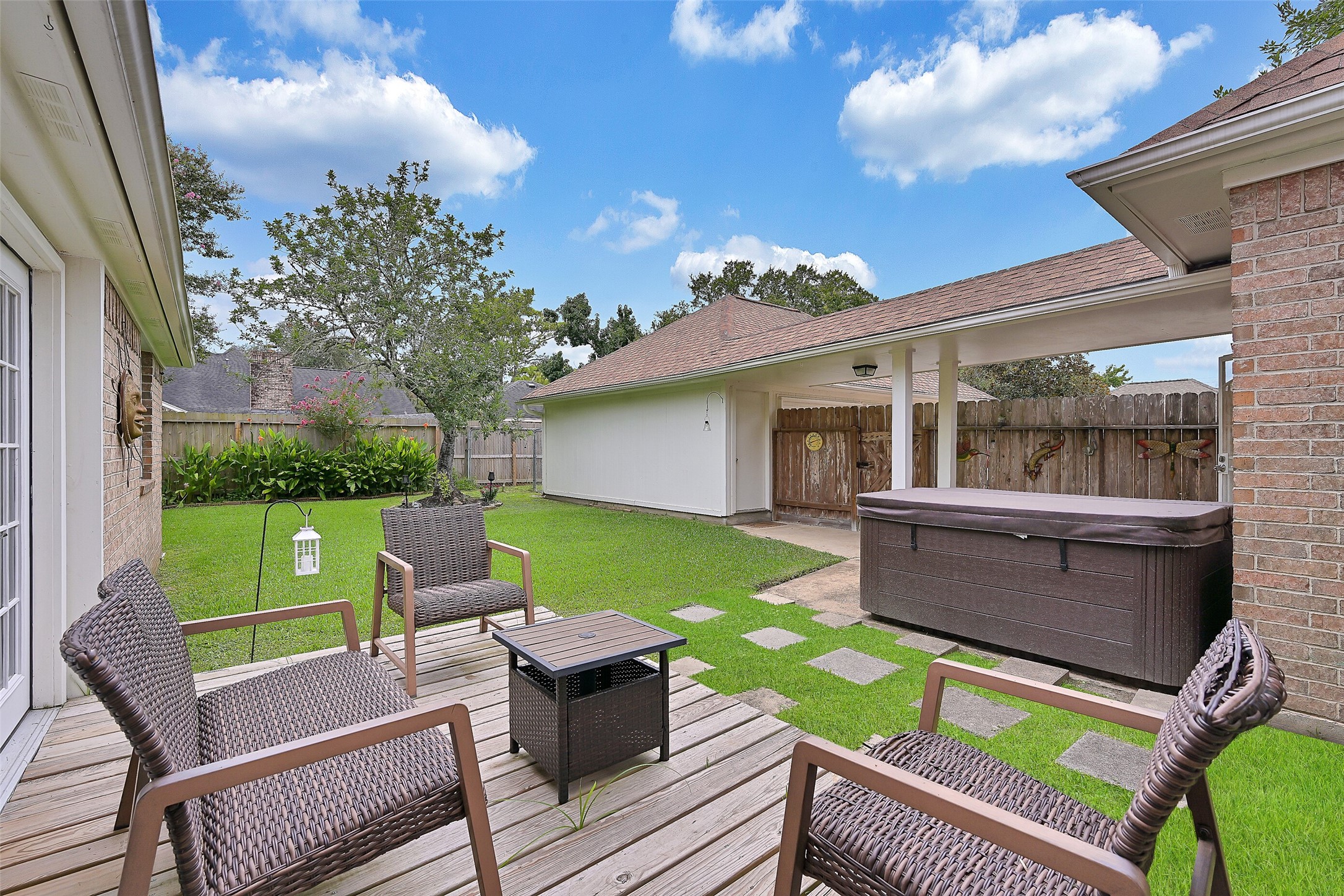 1606 Falcon Ridge Boulevard Friendswood, TX 77546 - Photo 22 of 24 a view of a patio with couches chairs and a yard