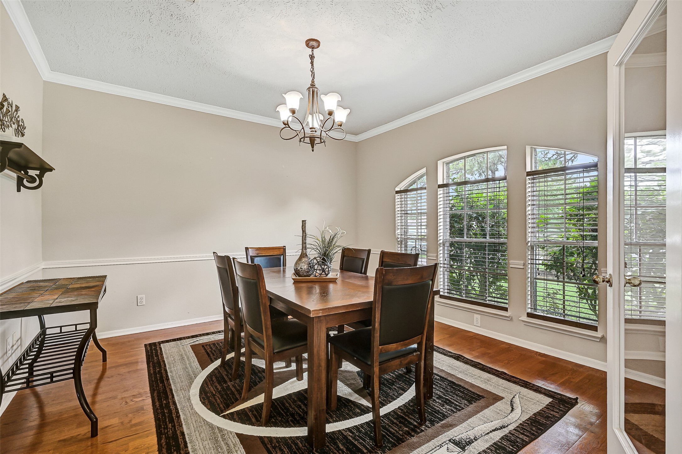 1606 Falcon Ridge Boulevard Friendswood, TX 77546 - Photo 5 of 24 a view of a dining room with furniture a chandelier and wooden floor