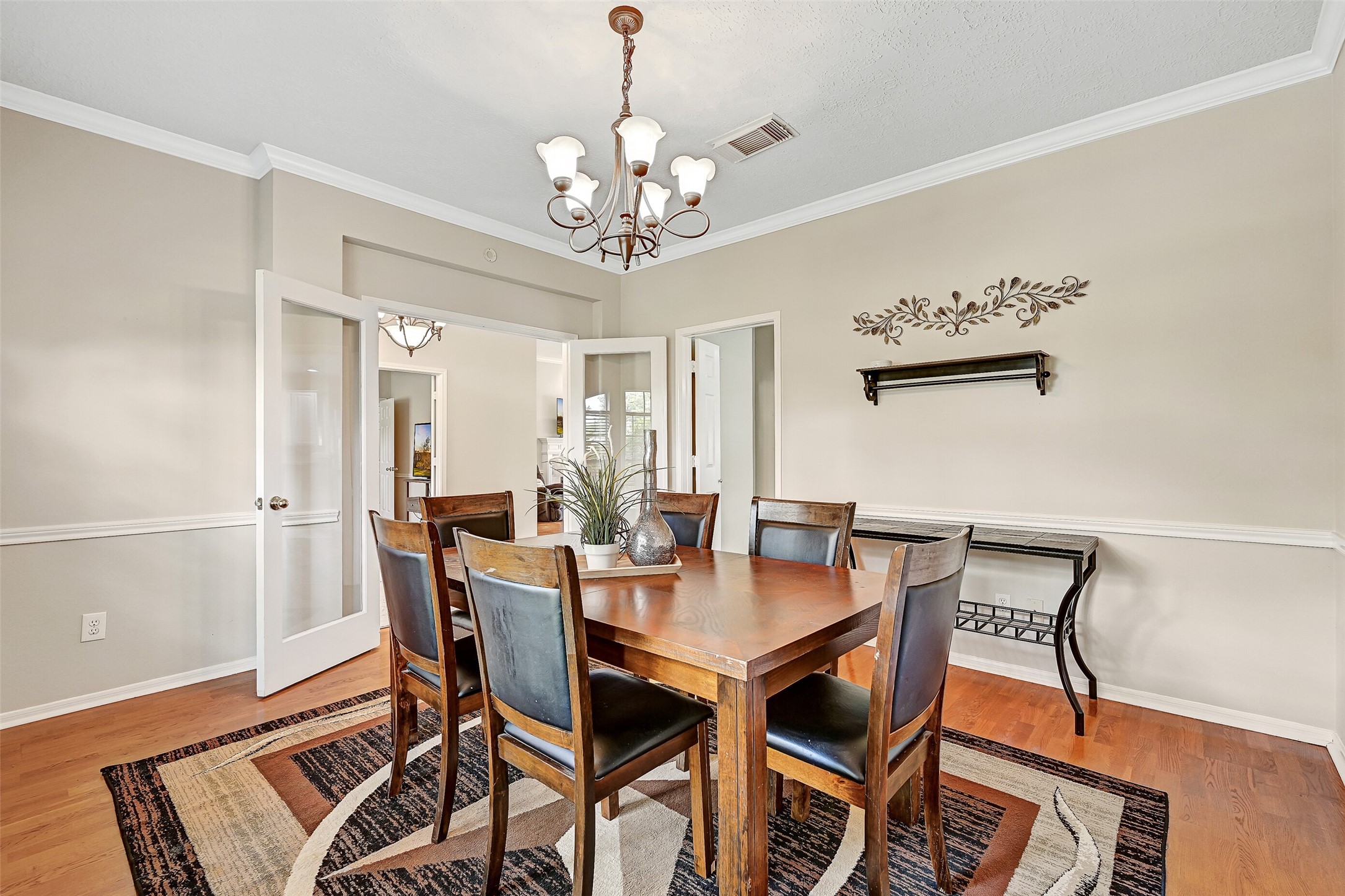 1606 Falcon Ridge Boulevard Friendswood, TX 77546 - Photo 6 of 24 a view of a dining room with furniture and chandelier