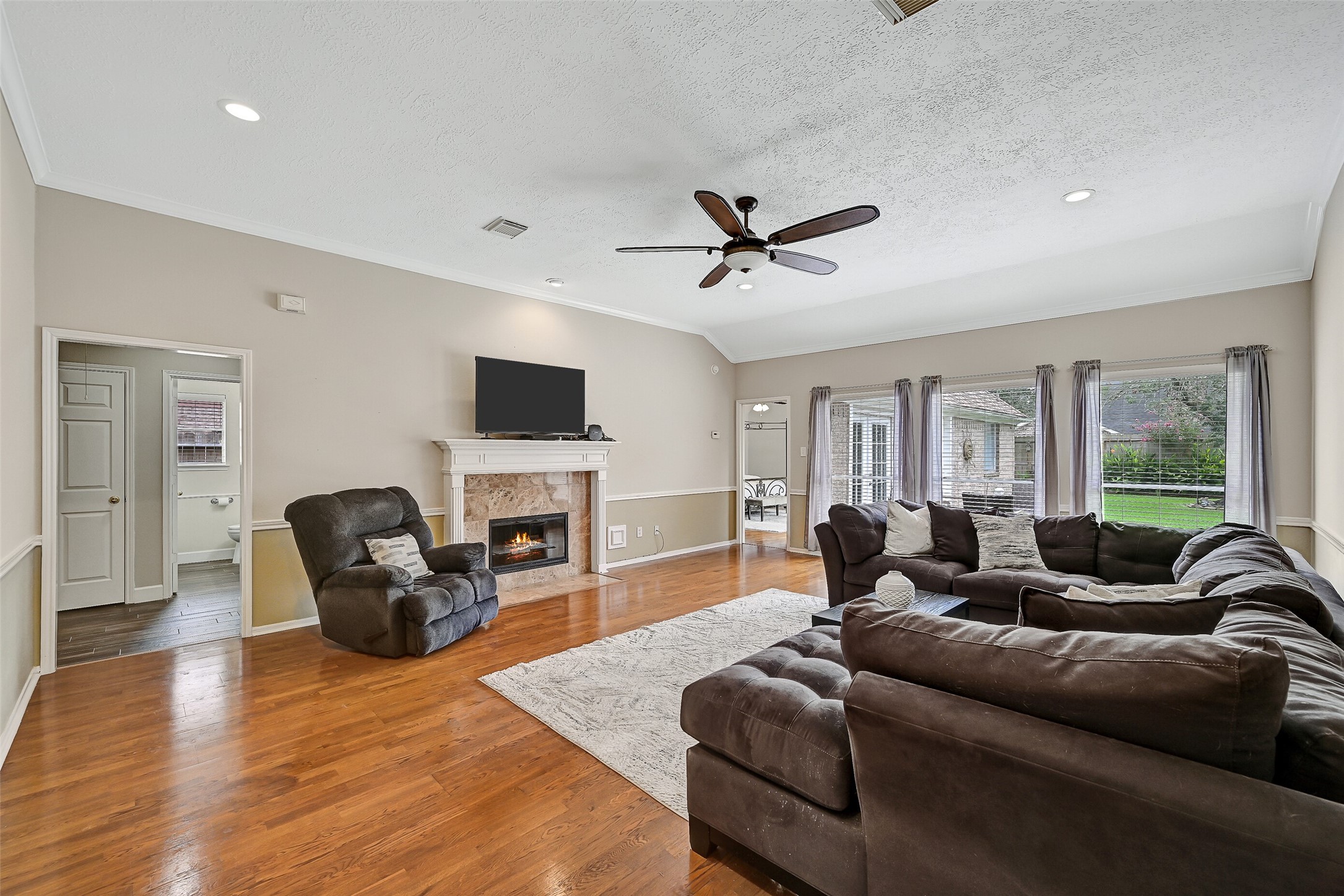 1606 Falcon Ridge Boulevard Friendswood, TX 77546 - Photo 10 of 24 a living room with fireplace furniture and a flat screen tv