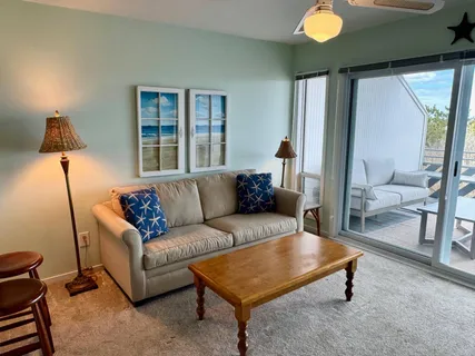 a living room with furniture and a lamp