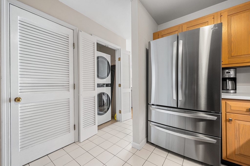 63 Garden Road, Unit C5 Wellesley, MA 02481 - Photo 8 of 30 a kitchen with stainless steel appliances a refrigerator and cabinets