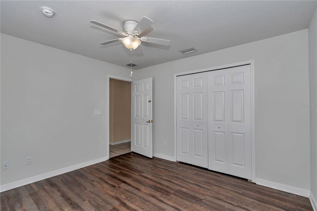 57 Chrysanthemum Drive Ormond Beach, FL 32174 - Photo 16 of 35 a view of an empty room with wooden floor