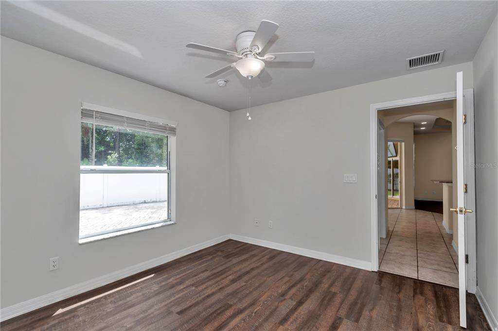 57 Chrysanthemum Drive Ormond Beach, FL 32174 - Photo 17 of 35 wooden floor in an empty room with a window