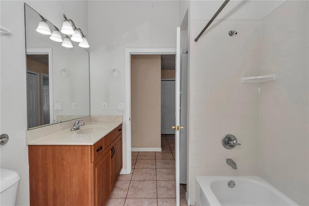 57 Chrysanthemum Drive Ormond Beach, FL 32174 - Photo 18 of 35 a bathroom with a tub a sink and a mirror