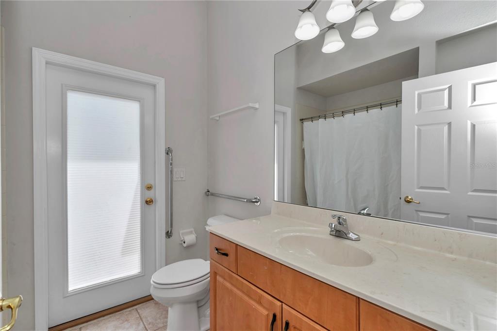57 Chrysanthemum Drive Ormond Beach, FL 32174 - Photo 19 of 35 a bathroom with a granite countertop sink toilet and mirror