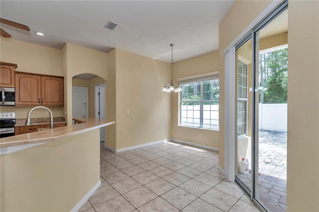 57 Chrysanthemum Drive Ormond Beach, FL 32174 - Photo 22 of 35 a kitchen with stainless steel appliances granite countertop a stove a sink and a refrigerator