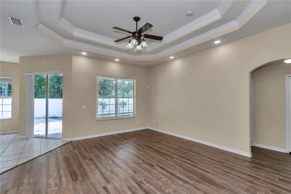57 Chrysanthemum Drive Ormond Beach, FL 32174 - Photo 24 of 35 a view of an empty room with wooden floor and a window