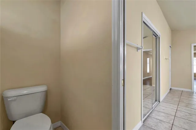 a view of a hallway with wooden floor and entryway