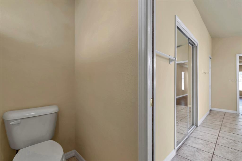 57 Chrysanthemum Drive Ormond Beach, FL 32174 - Photo 27 of 35 a white toilet sitting next to a bathroom sink