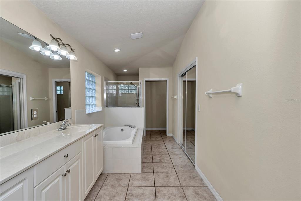 57 Chrysanthemum Drive Ormond Beach, FL 32174 - Photo 29 of 35 a spacious bathroom with a double vanity sink and a mirror