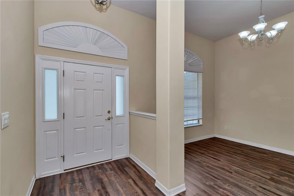 57 Chrysanthemum Drive Ormond Beach, FL 32174 - Photo 3 of 35 a view of a hallway with wooden floor