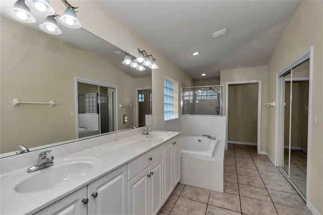 a large kitchen with a large window and stainless steel appliances