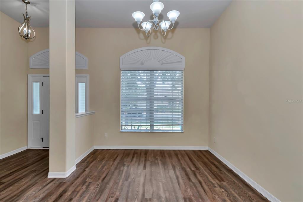57 Chrysanthemum Drive Ormond Beach, FL 32174 - Photo 4 of 35 a view of an empty room with wooden floor and a window