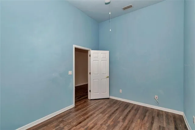 a view of an empty room with closet