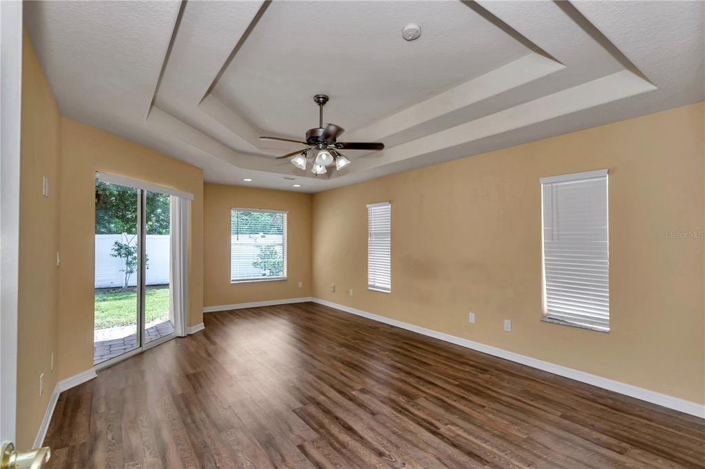 57 Chrysanthemum Drive Ormond Beach, FL 32174 - Photo 8 of 35 a view of an empty room with wooden floor and a window