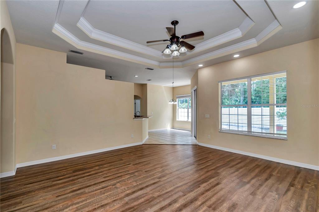 57 Chrysanthemum Drive Ormond Beach, FL 32174 - Photo 9 of 35 a view of an empty room with wooden floor and a window