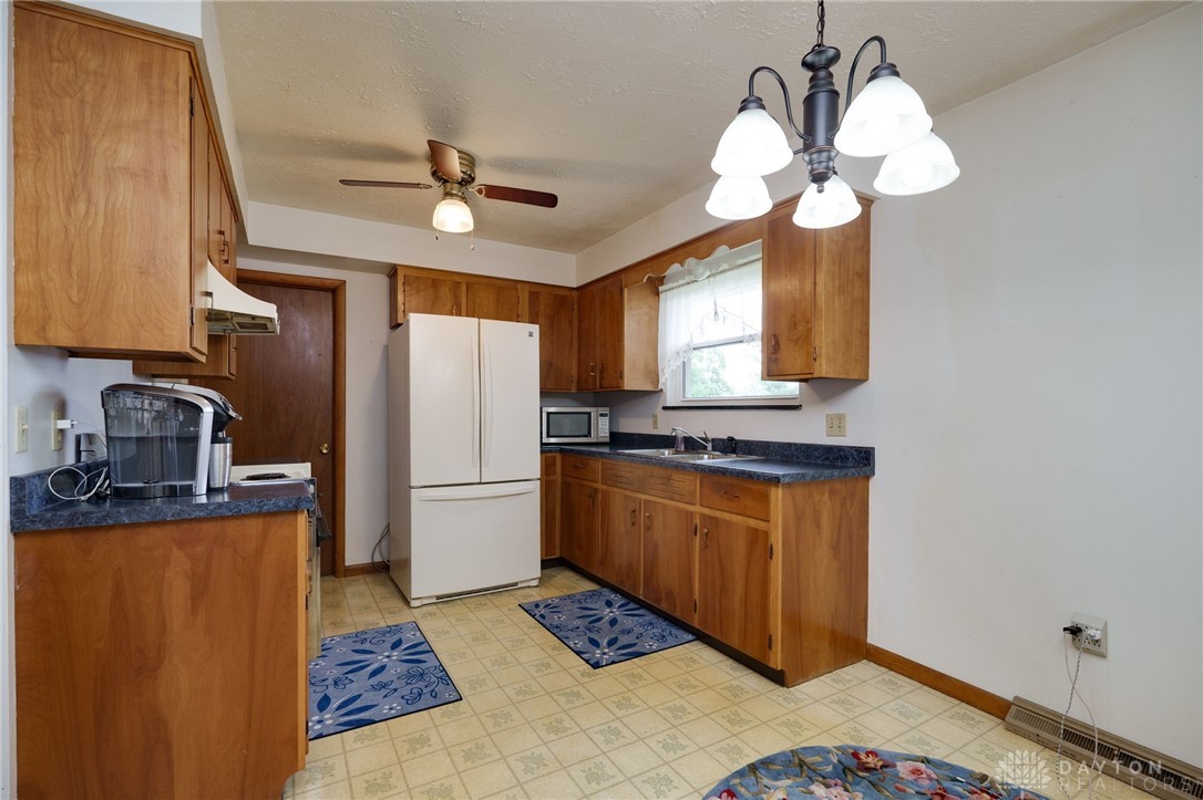 830 South Fuls Road New Lebanon, OH 45345 - Photo 6 of 28 Pristine kitchen with wood cabinets and a window to view the country.