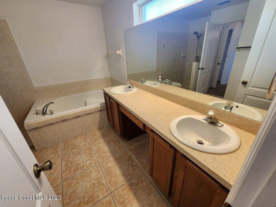 2004 Gloria Circle Palm Bay, FL 32905 - Photo 16 of 54 a bathroom with a sink and a mirror