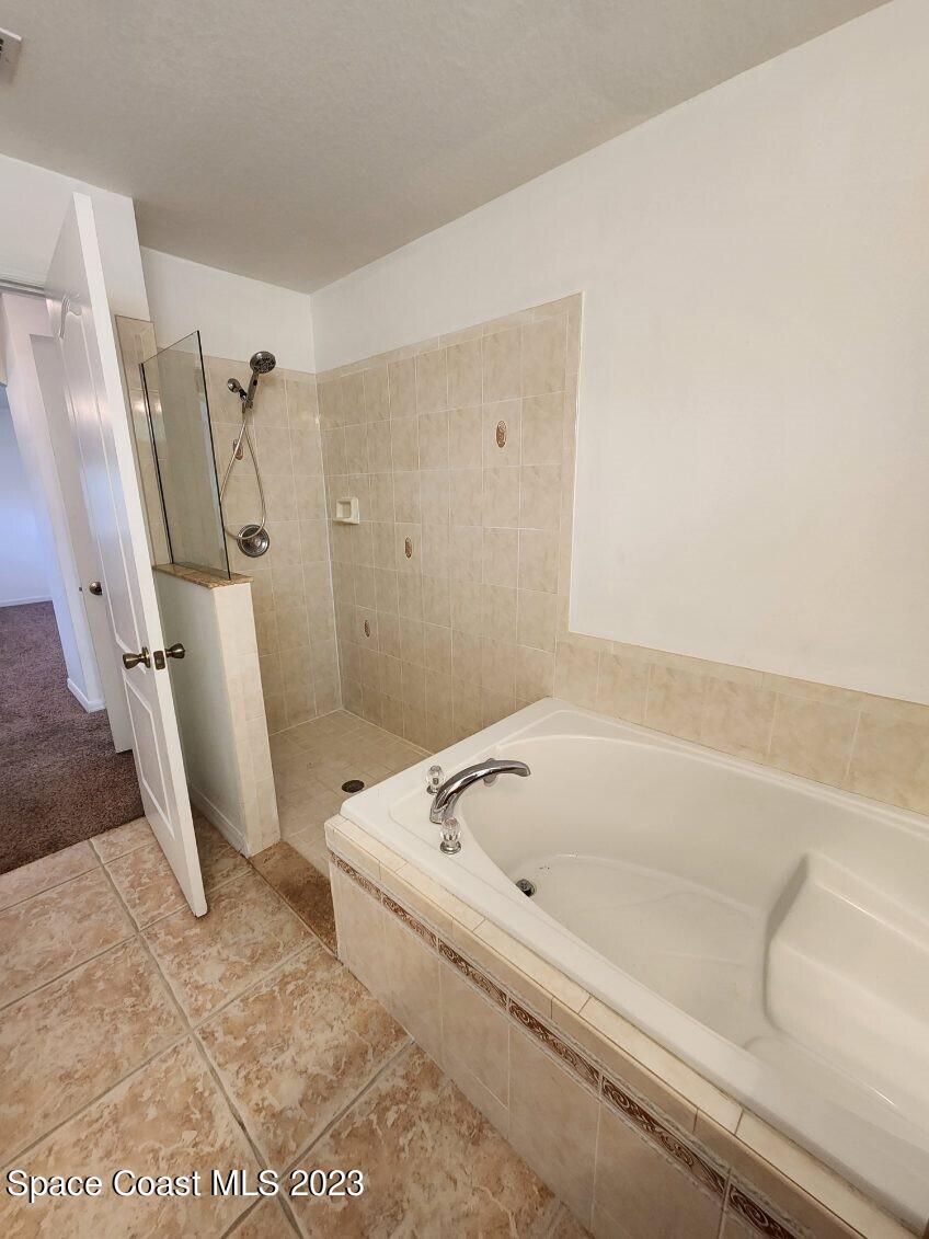 2004 Gloria Circle Palm Bay, FL 32905 - Photo 17 of 54 a bathroom with a tub and a window